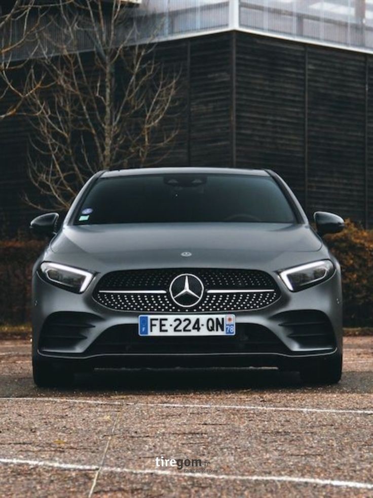 Front view of a matte black car parked outdoors with license plate FE-224-QN visible.